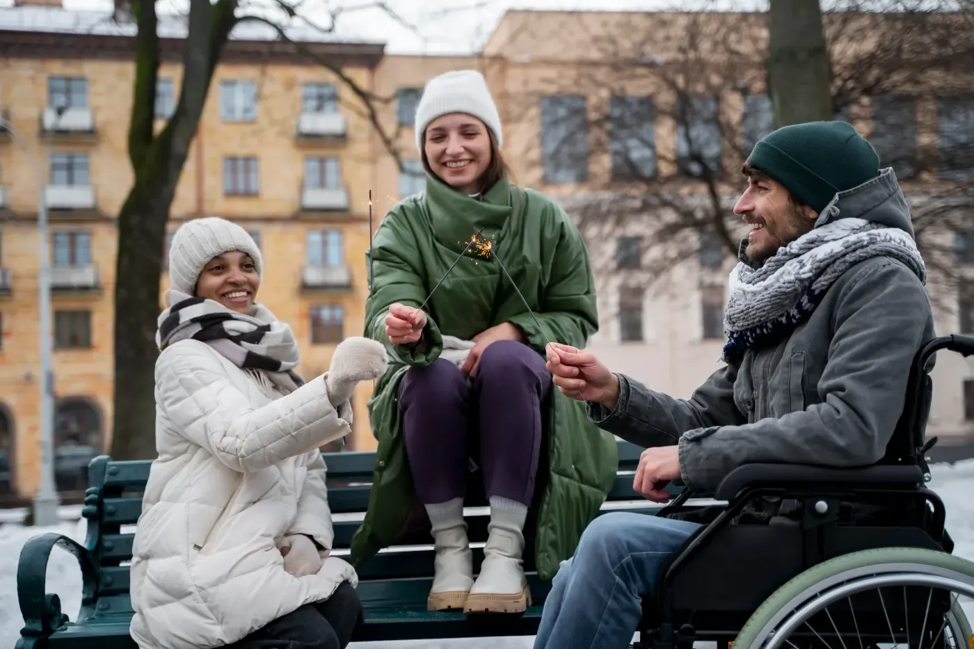 Two women enjoying time together outdoors with one using a wheelchair